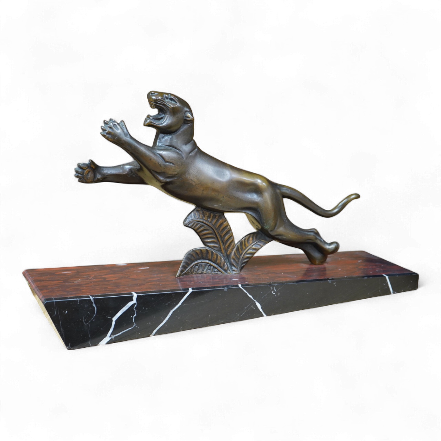 A French Art Deco bronze sculpture of a panther, raised on slanted base, 44cm wide